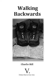 Pamphlet cover for Walking Backwards by Charlie Hill featuring black walking boots resting on an open map. 